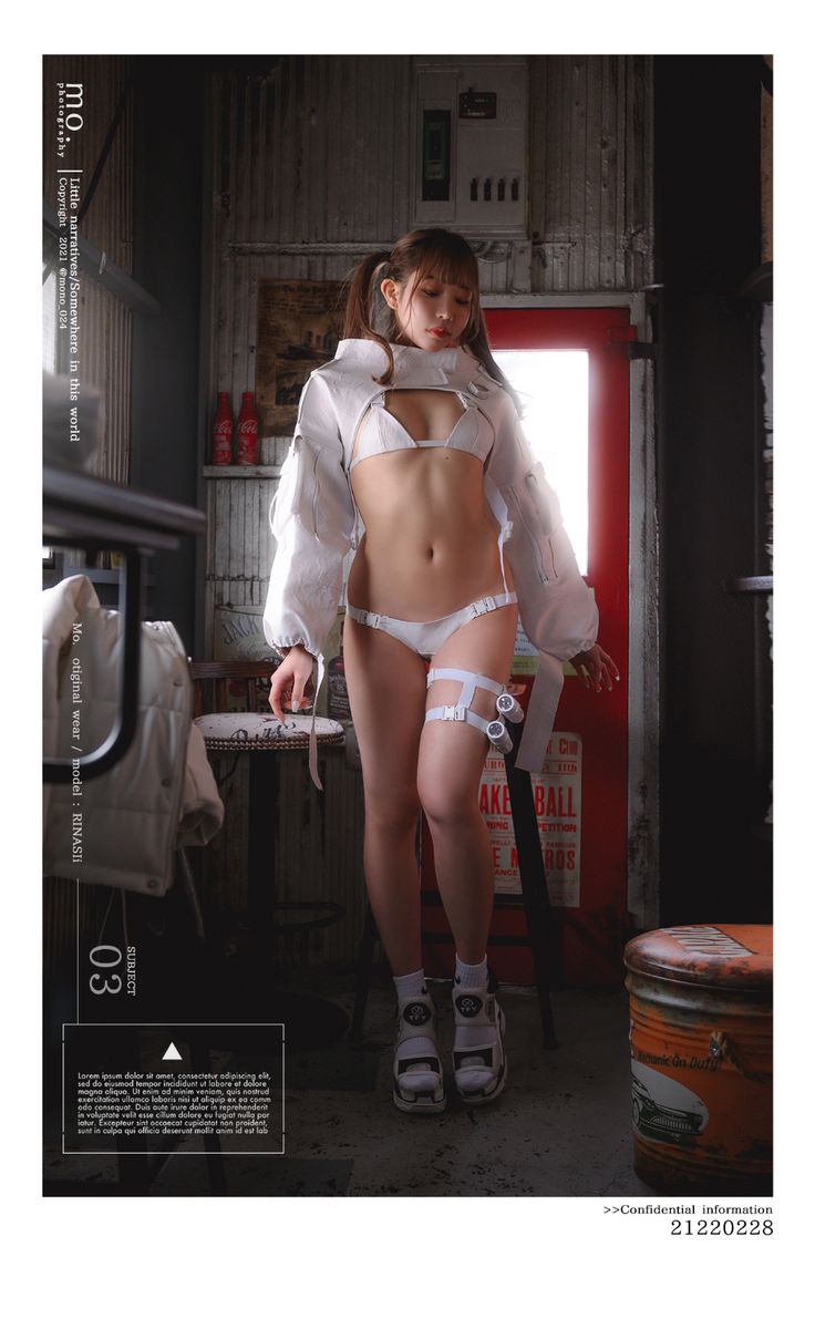 a woman is standing in front of a red brick wall. she's wearing a white jacket, white bikini and white kneehigh boots. she is looking at the camera and is posing.  the photo is taken in a dimly lit room with a barstool in the background.