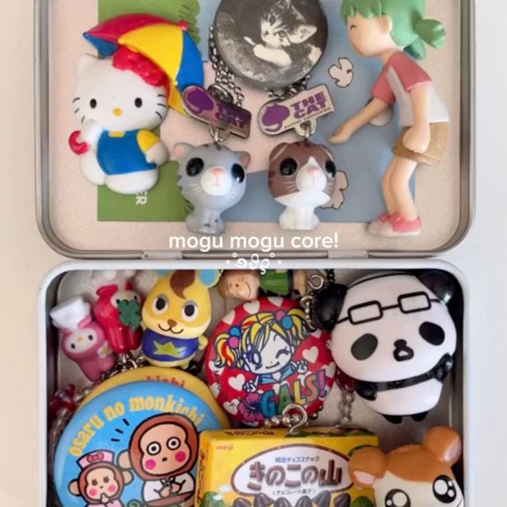 this image features a tin box with a collection of cute keychains, figurines, and stickers. there are cartoon characters like hello kitty, anime figures, and a japanese candy box.