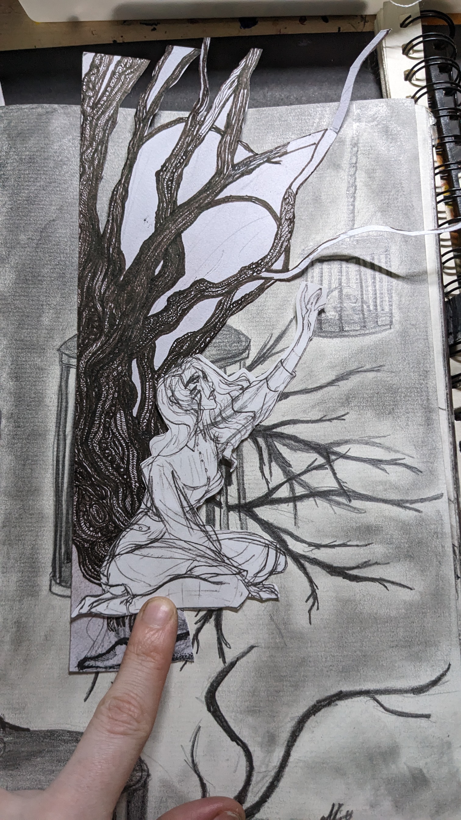 an image of a drawing of a woman, her face is not fully visible, in front of a tree with bare branches.  the drawing is done in pencil and charcoal, using a dark gray color for the tree and branches. the woman is drawn with a lighter gray shade, with no features visible on her face. the drawing is on a piece of paper with the corner folded over. a hand and fingers are visible holding the drawing.