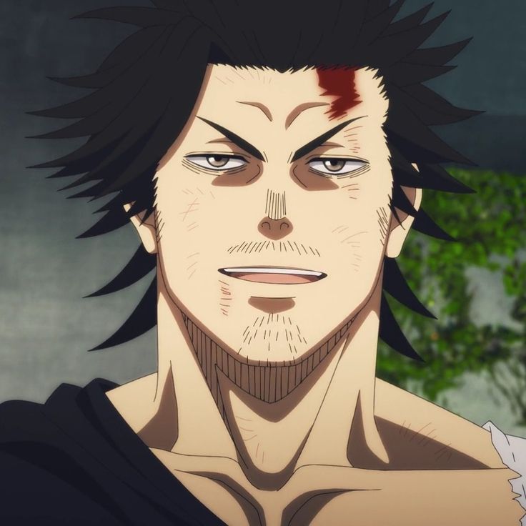 a closeup shot of yami sukehiro, the captain of the black bulls in the anime black clover. he is a muscular man with dark skin, black hair, and scars all over his face. yami is smiling, but there is a hint of seriousness in his eyes. he is wearing a black shirt with a white collar and has a scar above his right eye. the background is blurred and there are some green leaves in the background.