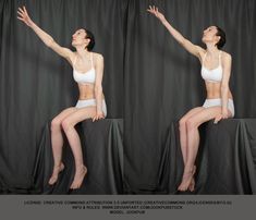 a woman in a white sports bra and underwear sits on a platform and reaches up with her right arm, her left arm relaxed at her side. the image is duplicated side by side against a dark gray backdrop. this appears to be a reference photo for artists.