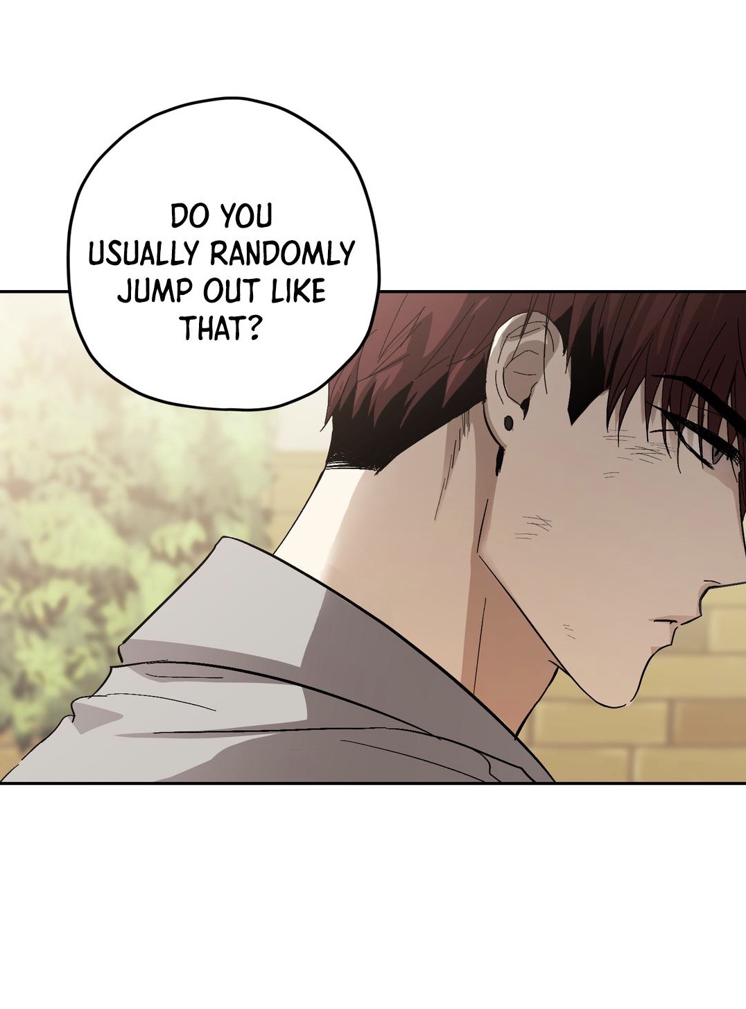 the image is a panel from a comic, likely manhwa or manga, showing a closeup of a young man's profile. he has short brown hair and is wearing casual clothing. a speech bubble above him contains the question: "do you usually randomly jump out like that?". the background suggests an outdoor setting near a building. the overall style is realistic with soft shading and coloring. the man's expression is somewhat pensive or surprised.