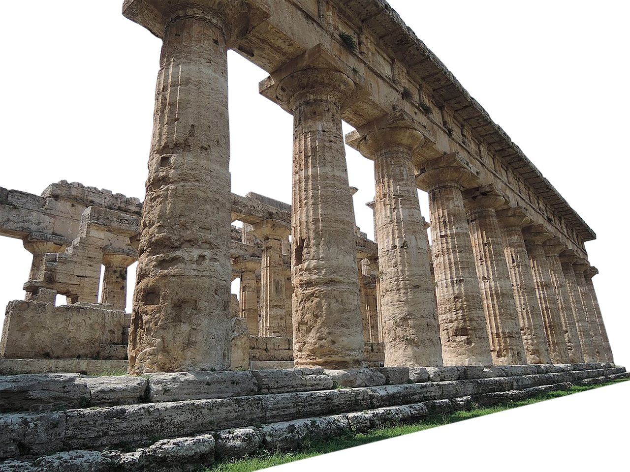 the image shows the ruins of an ancient stone temple with doric columns. the weathered stone reveals the age and history of the structure.
