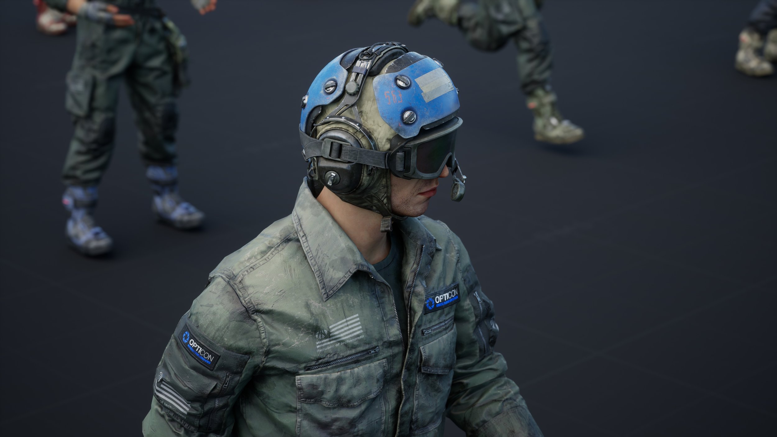 closeup view of a soldier or pilot wearing a military flight suit and helmet. the helmet is darkcolored with blue accents and protective goggles. the suit features camouflage patterning and patches, including one with the "opticon" logo and another with a small american flag. the soldier's face is partially visible, and the expression is serious. the background is out of focus but shows other military personnel and a dark tarmaclike surface, possibly indicating a training exercise or military base. the overall impression is one of readiness and professionalism.
