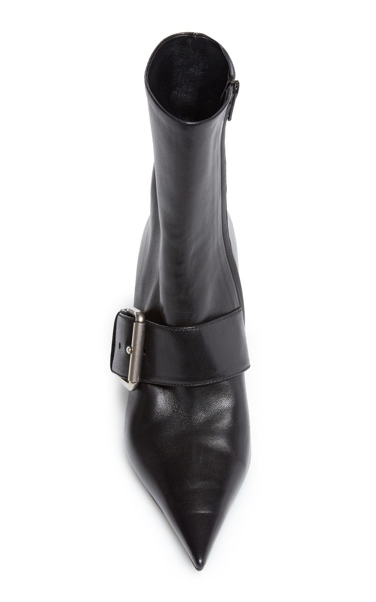 a pair of black leather women's ankle boots with a pointed toe and a single buckle strap around the ankle. the boots are shown from a topdown perspective against a white background. the leather appears smooth and the buckle is silvertoned. the boots have a sleek, sophisticated look.