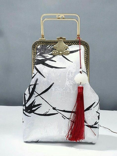 the image shows a handbag with a white fabric body, black bamboo leaf pattern, gold trim, gold handle, and a red tassel. it appears to be of oriental style.