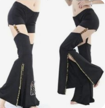 two women are modeling a pair of black belly dance pants. the pants have a high waist, short shorts, and long, flowing legs with side slits that are decorated with gold studs. the pants also feature a decorative design on the lower left leg.