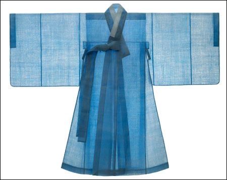 the image features a light blue hanbok, which is a traditional korean dress. the hanbok is neatly laid out and features long, wide sleeves and a flowing skirt. it is tied at the front with long ribbons. the overall style of the hanbok suggests it is for women.