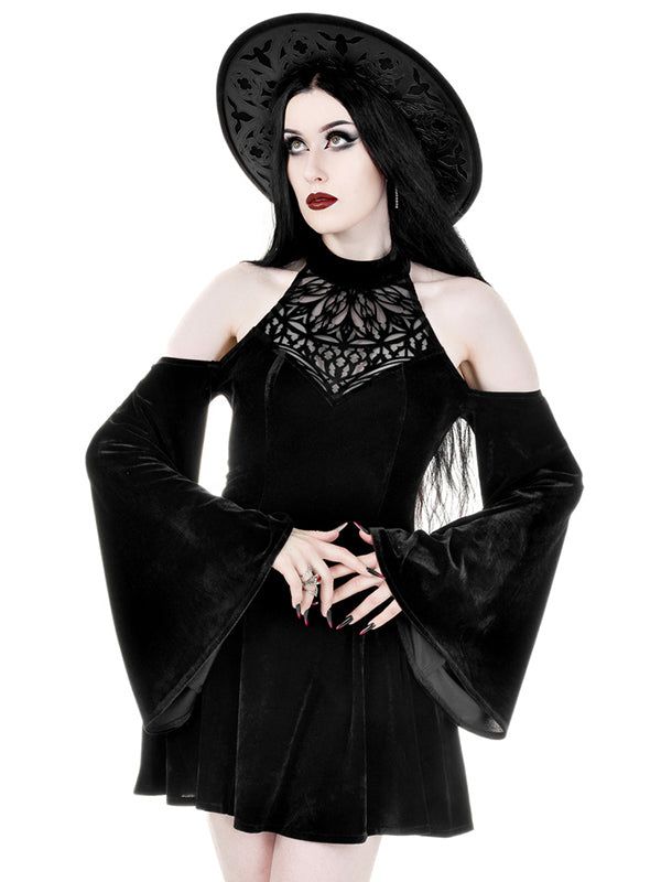 a woman wearing a black velvet dress with lace detail and a black hat is posing for a photoshoot. she is wearing a gothic style and is dressed in a formal and elegant outfit. the dress is a beautiful blend of velvet and lace, and the hat is a perfect complement to the entire look.