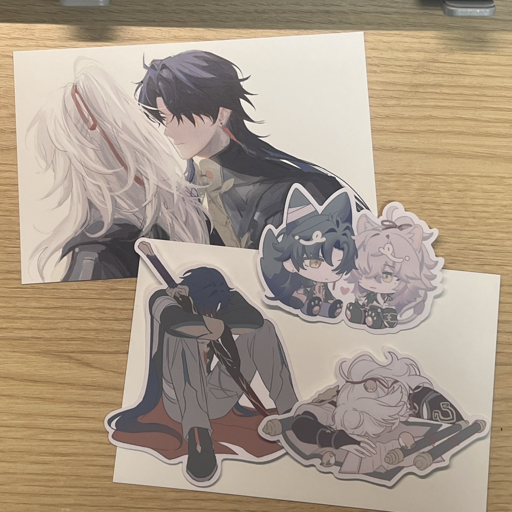 the image shows a collection of anime character stickers. there are three stickers in total. one sticker features a male character with long black hair and blue eyes and a female character with white hair and blue eyes. they are embracing each other romantically. another sticker is of a smaller anime character with black hair and green eyes. the third sticker is also of a smaller anime character with pink hair and blue eyes. all the stickers are on a white background and are in a cute and cartoonish style.