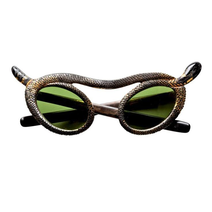 a pair of unusual sunglasses featuring a snake design is centered in the image. the frames are crafted to resemble a serpent, with the snake's body wrapping around the lenses and its head positioned at the temples. the sunglasses have oval lenses with a green tint. the snake design is detailed with scaly textures.