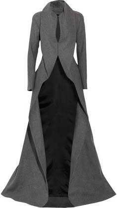 a woman is wearing a grey long coat with a black lining. the coat is open and the lining is showing. the coat is long and flowing, and has a fitted bodice and flared skirt. the woman is standing with her arms by her sides.
