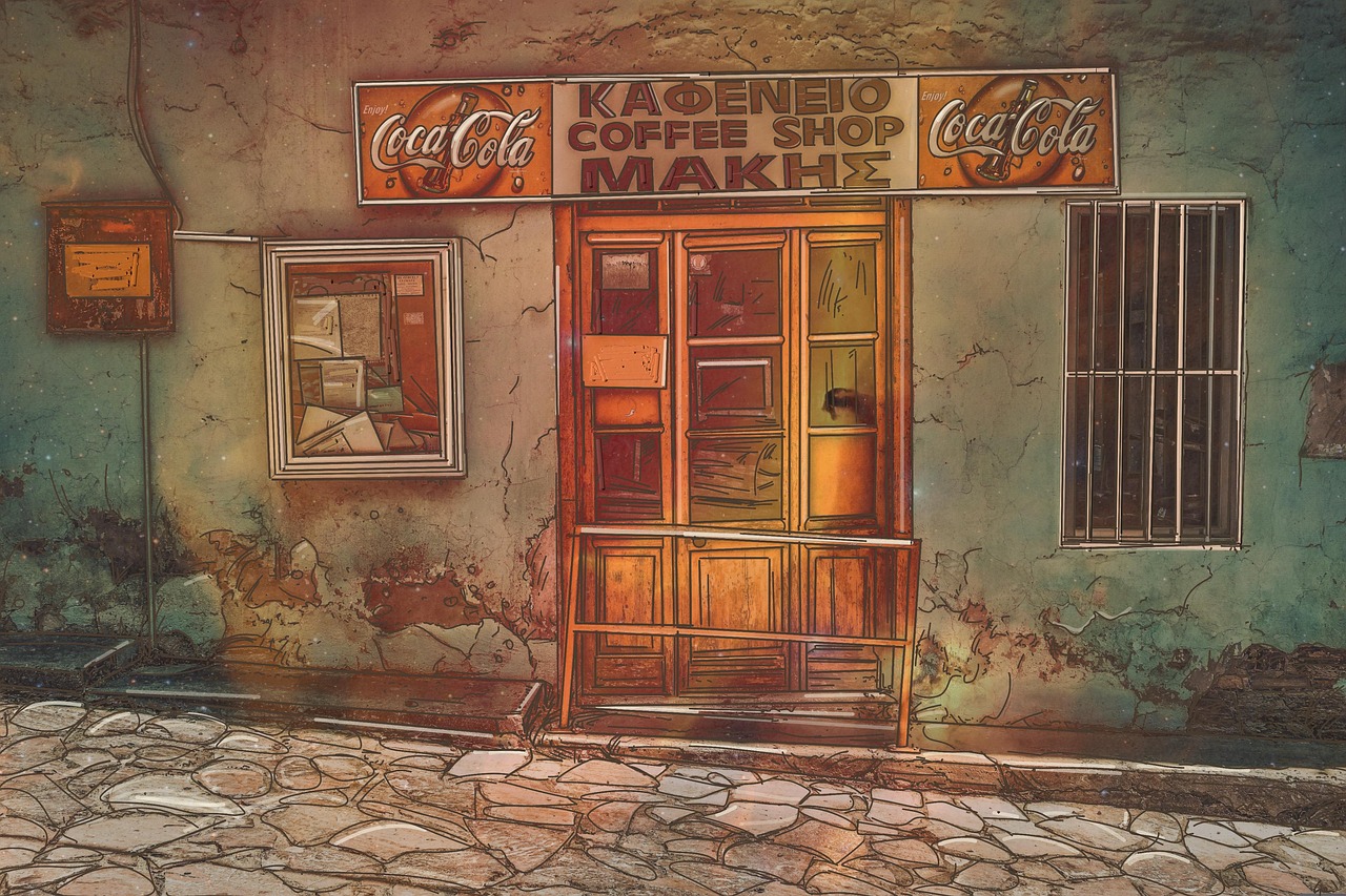 an oldfashioned coffee shop called "coffee shop makis" with cocacola signs on a building with a cracked wall, a window with bars, and a cobblestone street.