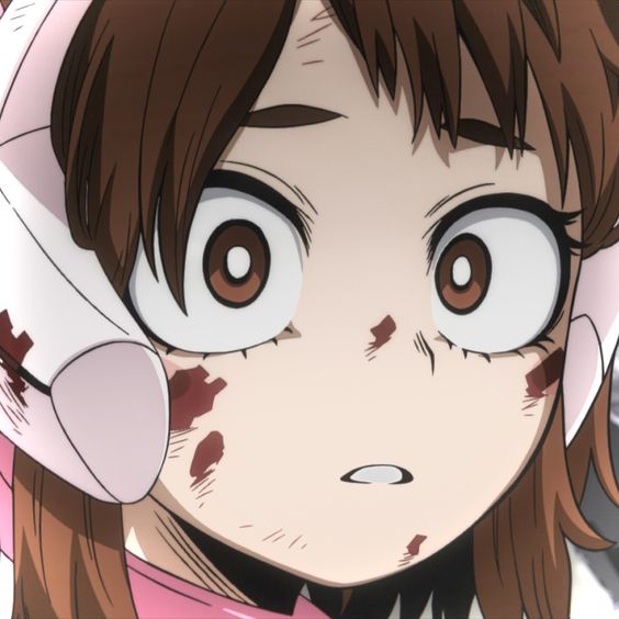 this is a closeup illustration of an anime girl with short brown hair and brown eyes. she appears to be injured, with blood splattered on her face and a look of fear or concern in her eyes. the background is not shown, focusing the attention on the girl's expression.