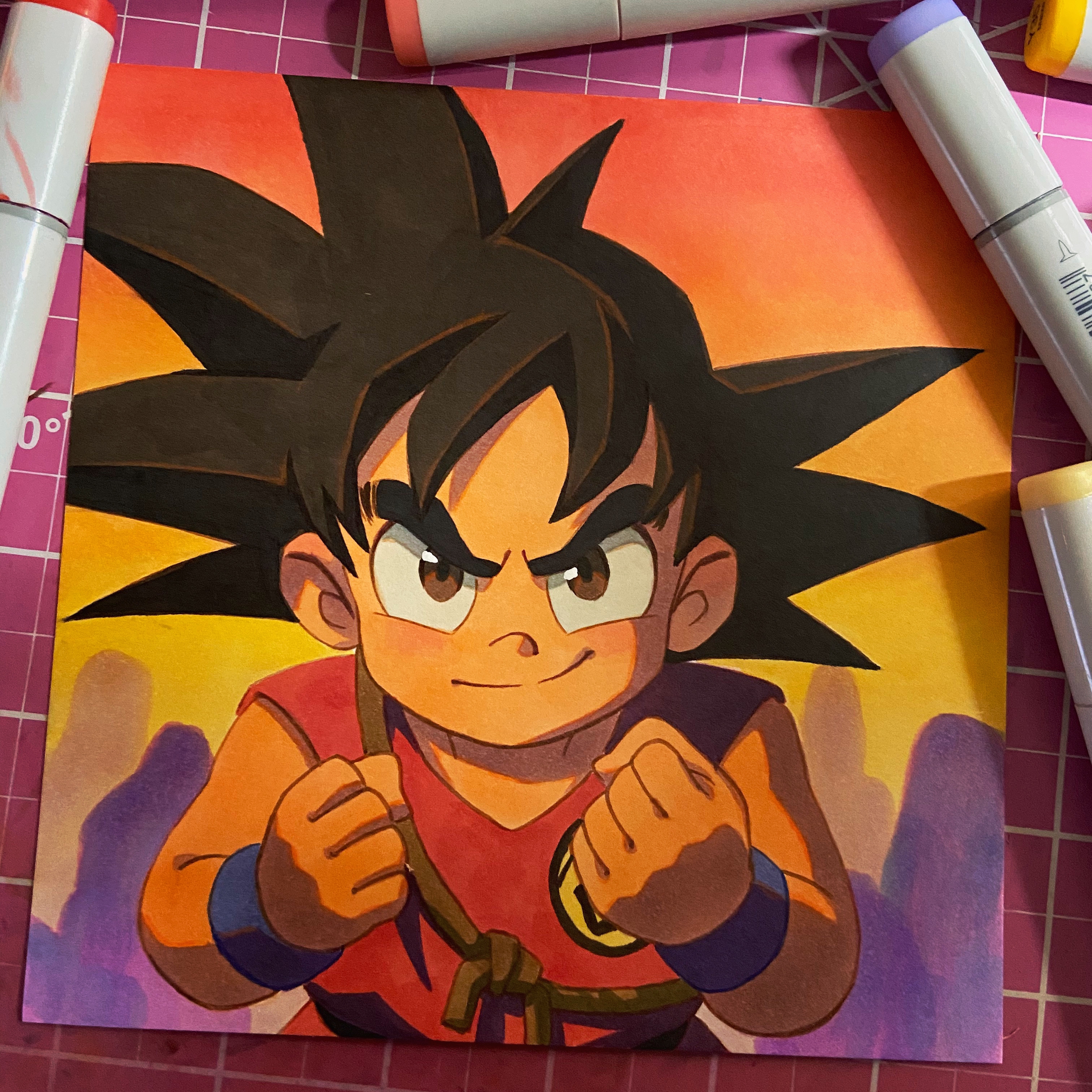 a drawing of goku from dragon ball in his fighting stance. the image is drawn in marker and is colorful. goku is young and determined with a confident expression. he has spiky black hair, and his eyes are wide open. the background is orange and yellow, and there are purple silhouettes of other figures.