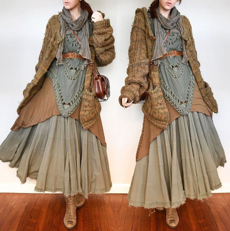 a woman is showcased in an outfit featuring a layered bohemian style. she wears a knitted cardigan, a tiered dress with varying shades of brown and gray, a scarf, and a belt. her look is completed with leather boots and a small leather bag. the outfit is in neutral, earthtoned colors, suggesting a fall or autumn theme. the fringed hem and vintage styling add to the bohemian vibe.