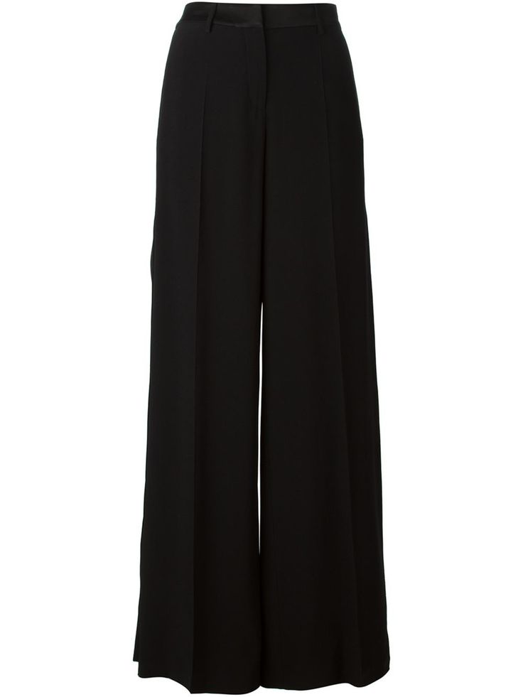 a pair of black, wideleg trousers are shown in the image. the trousers are highwaisted and appear to be made of a flowing fabric. they are displayed on a white background.