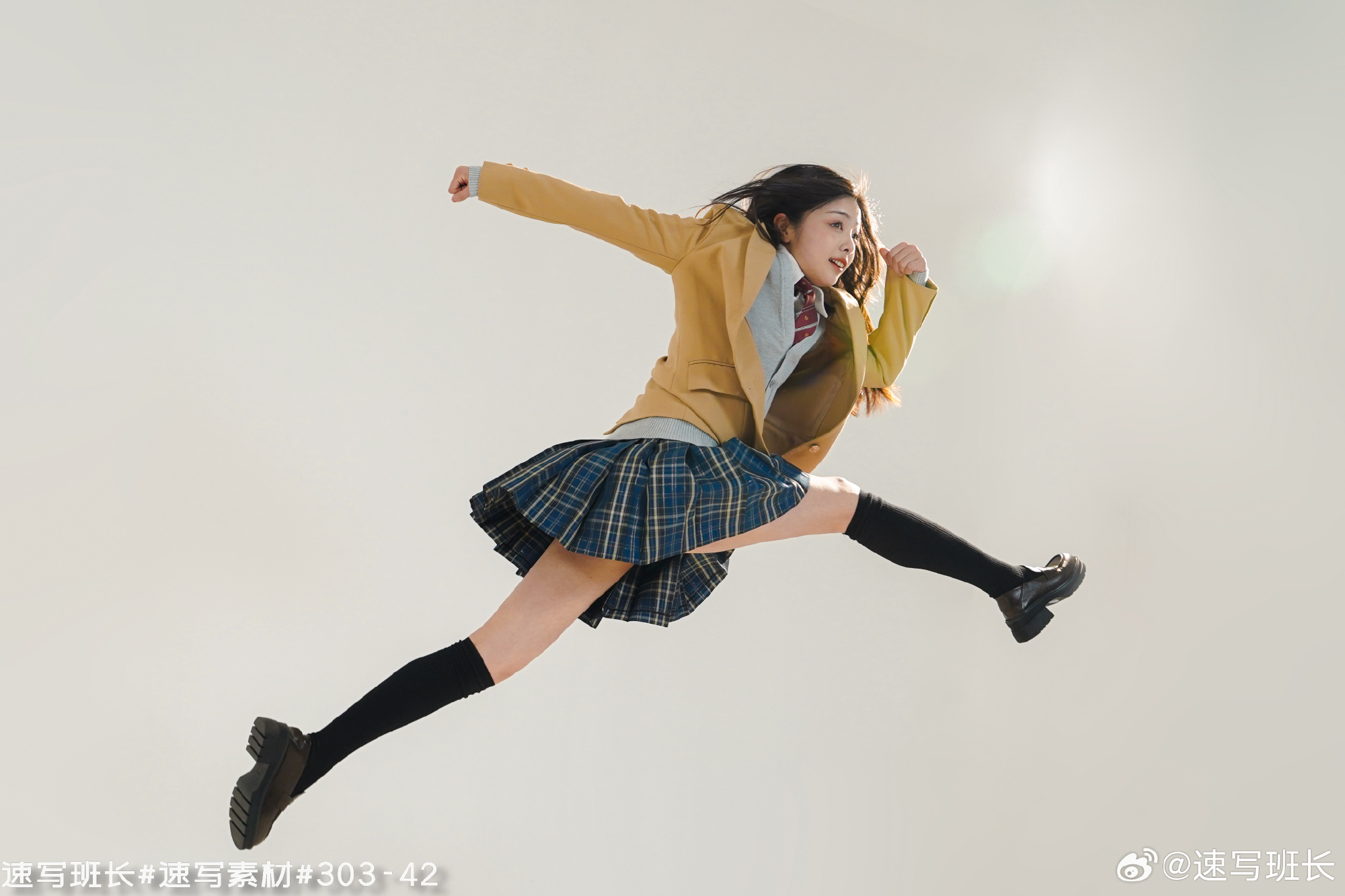 a young woman in a japanese school uniform is captured midair, executing a dynamic jump against a white background.  she's wearing a yellow blazer, a pleated blue and green plaid skirt, black kneehigh socks, and black loafers. her hair is long and dark, and she has a determined expression on her face. the bright lighting suggests an indoor studio setting, and the low camera angle emphasizes her height and the energy of her movement.