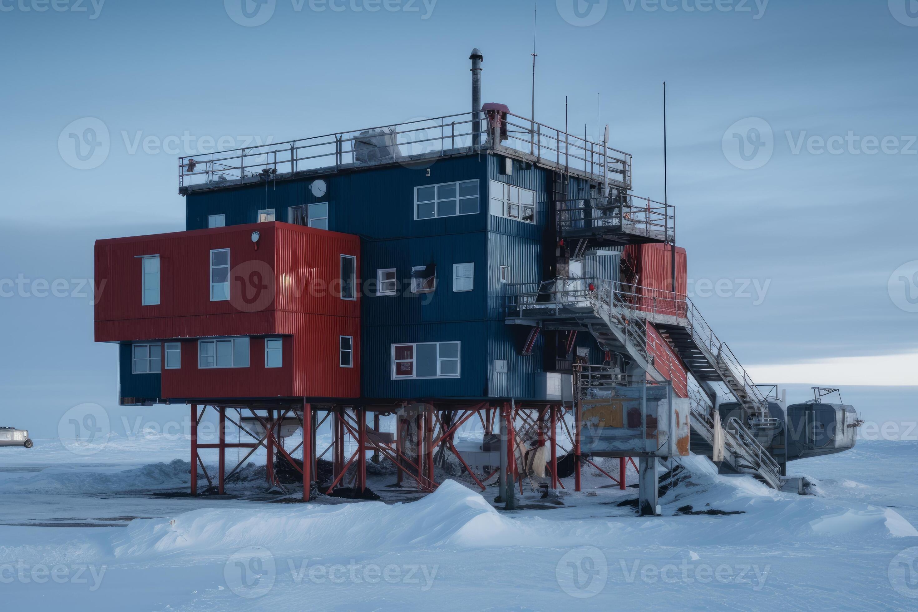 a colorful building stands tall on stilts in a snowy, desolate landscape. the building is painted in shades of blue and red, and is surrounded by a vast expanse of snow and ice. the sky is a hazy blue, and there are clouds in the distance. the building has a distinct industrial feel, and seems to be a research station or base camp. the harsh environment and remote location add to the sense of adventure and isolation.