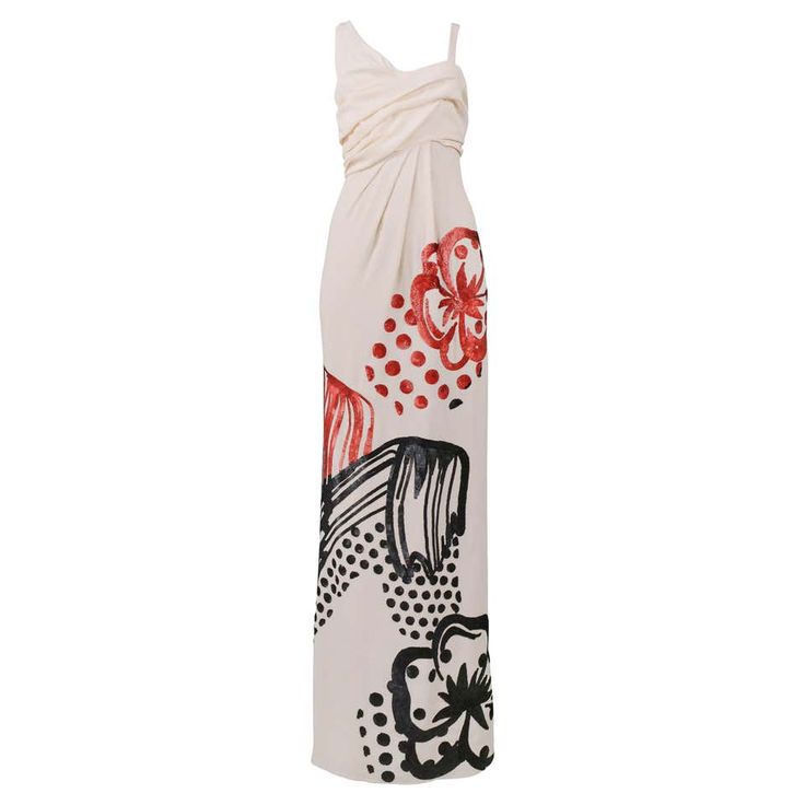 a white maxi dress with red and black floral prints. the dress is sleeveless and has a fitted bodice and a flowing skirt. it is perfect for a summer evening party or a special occasion.