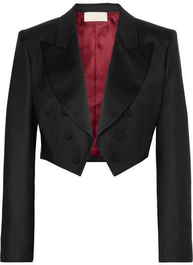 a cropped, black doublebreasted blazer or jacket with a red lining, likely part of a suit.