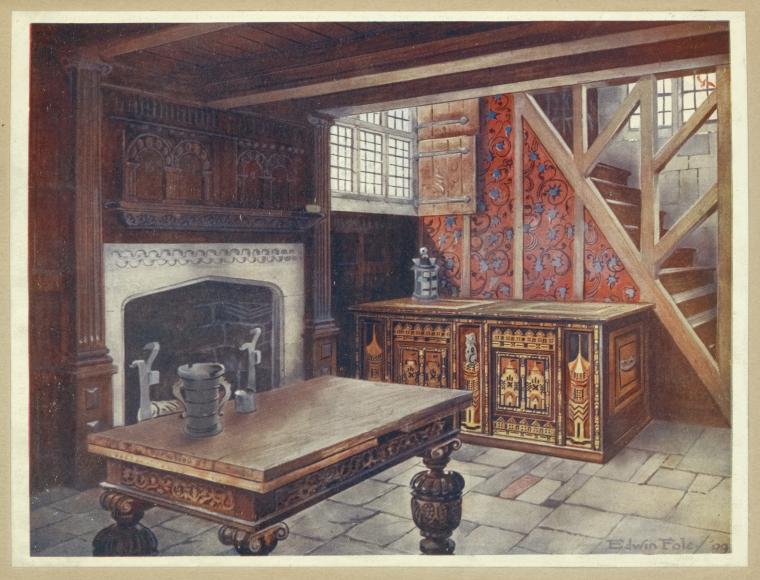an interior view of a room featuring a large stone fireplace with intricate wood paneling above, a wooden table with turned legs in the foreground, and a decorated chest against a wall with a window and a staircase leading to an upper level. the room has a medieval or tudor style, with stone flooring and detailed woodwork.