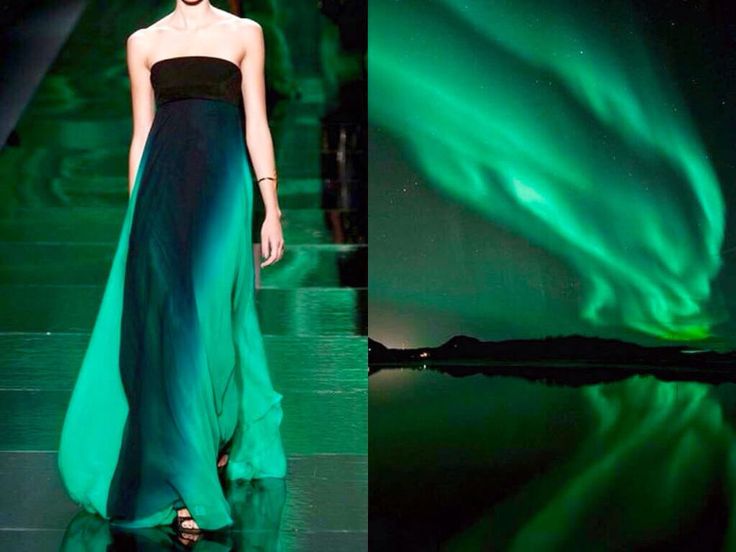 a woman in a teal ombre gown poses on a green runway. the gown is strapless with a black band around the bust. the background is blurred and out of focus, but it appears to be green. on the right side of the image, the northern lights are visible in the night sky, reflecting in a still body of water below. the woman's pose and the gown are elegant and the aurora borealis is a stunning display of nature's beauty. the image is a blend of fashion and nature, highlighting the beauty of both.
