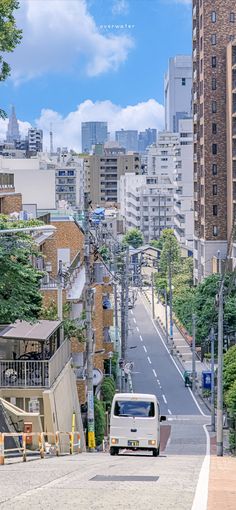 this is a street view in tokyo, japan. there are buildings on both sides of the street, and a white van is driving up the hill. the sky is blue and cloudy. there are trees lining the sidewalks and some greenery growing up the sides of the buildings. the photo is taken from a high vantage point.