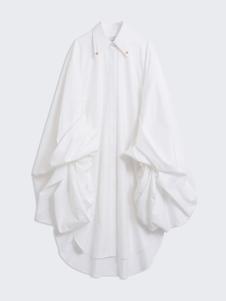 a white oversized shirt with puff sleeves, a collar, and buttons, hanging on a white background.