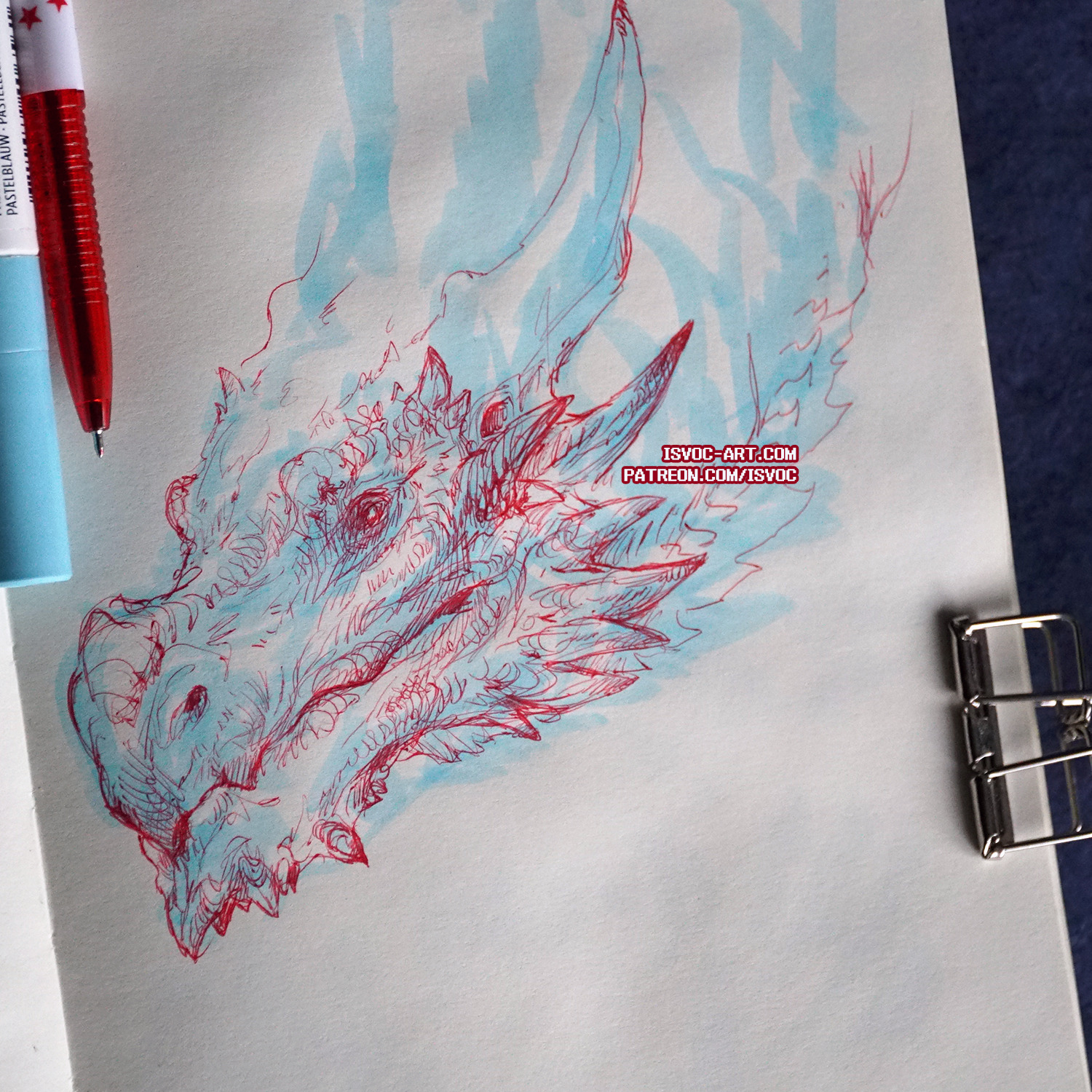 a detailed pen drawing of a dragon's head in profile view, rendered in red and blue ink on a sketchbook page. the drawing emphasizes the dragon's scales, horns, and expression.