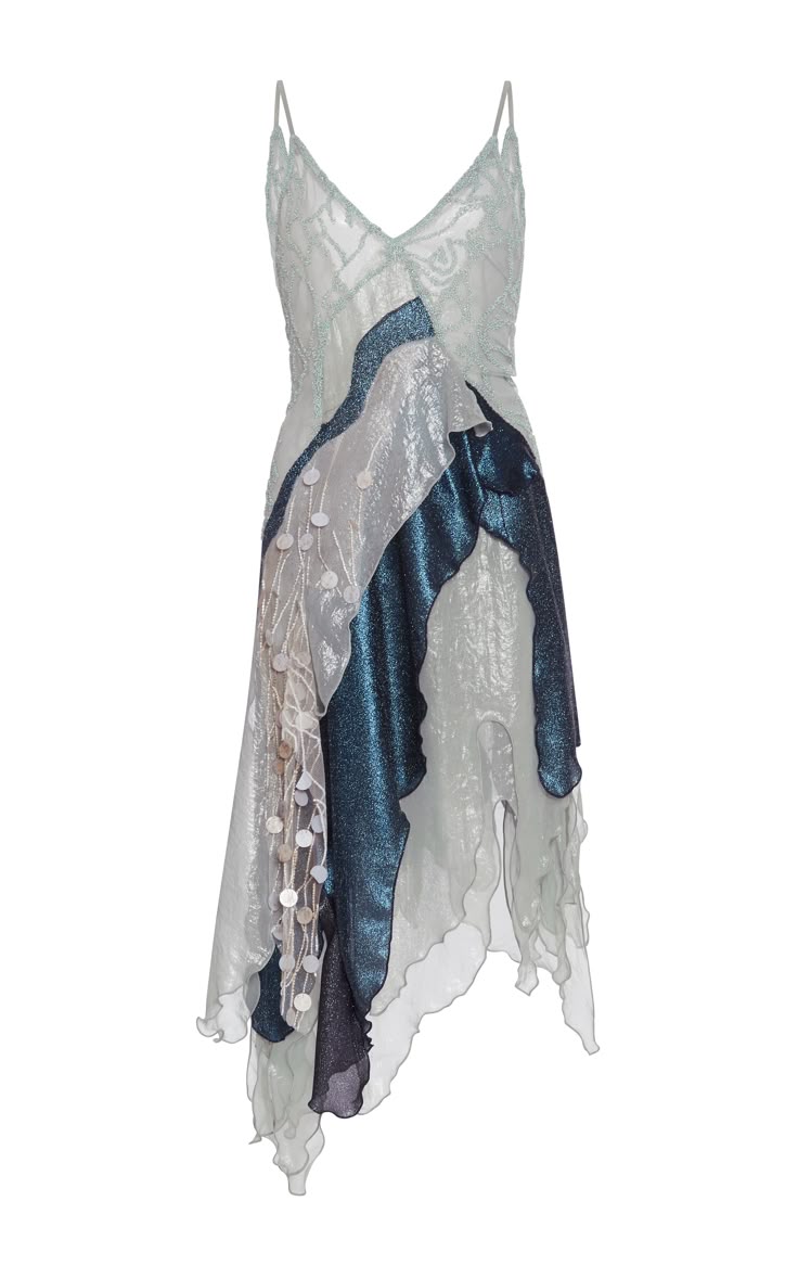 a women's dress on a white background. the dress has spaghetti straps, and the main colors are blue, gray, and white. the dress is shiny and decorated with sequins. the hem is irregular and asymmetrical.