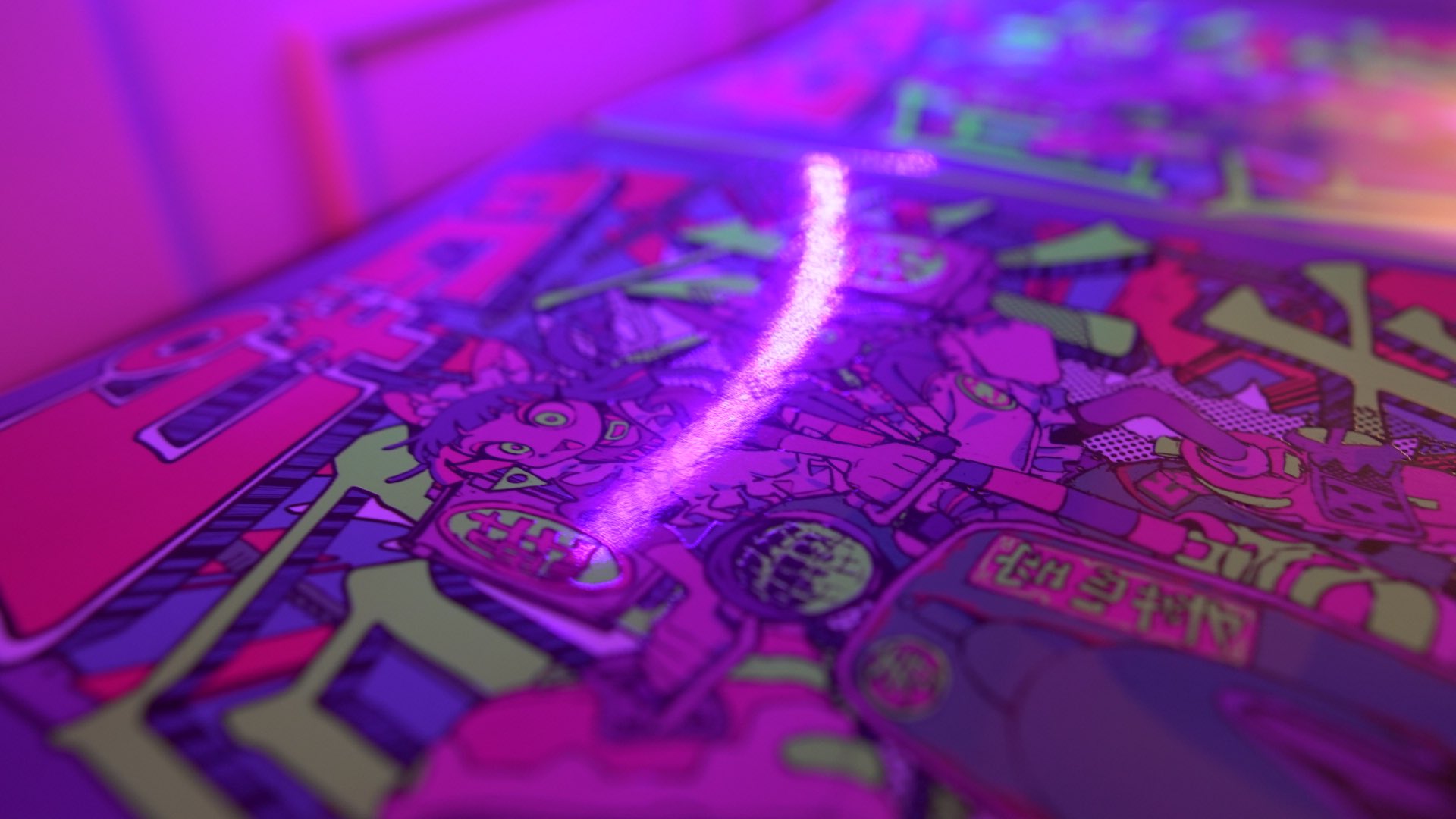 a closeup shot of a vibrant manga comic book cover illuminated by a bright pink neon light. the cover art features a stylized female character with exaggerated features and colorful, dynamic artwork in a cyberpunk or futuristic setting. the neon light creates a glowing effect, highlighting the details and colors of the illustration.