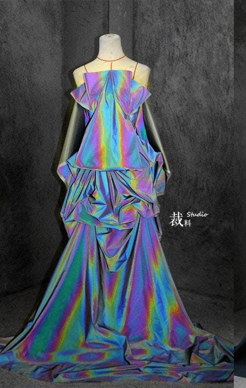 an iridescent dress on a mannequin in a studio.