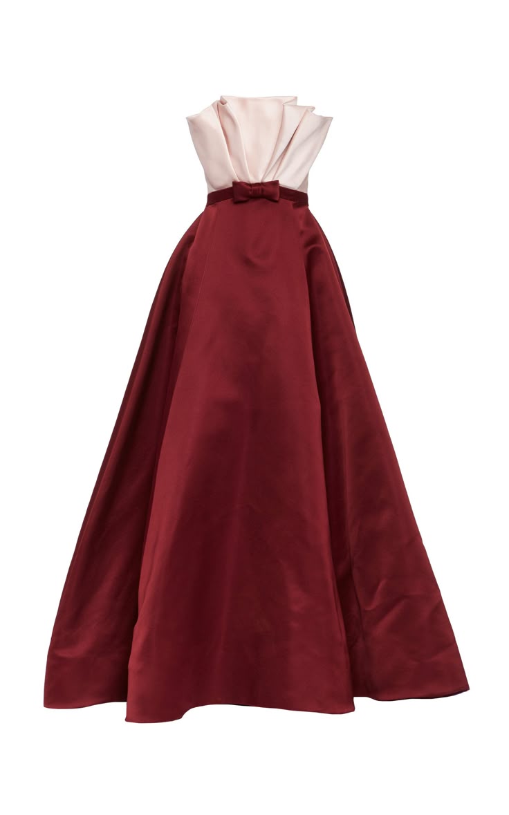 a formal, strapless, aline ball gown, with a light beige upper bodice and burgundy skirt, cinched with a bow at the waist, isolated on a white background.