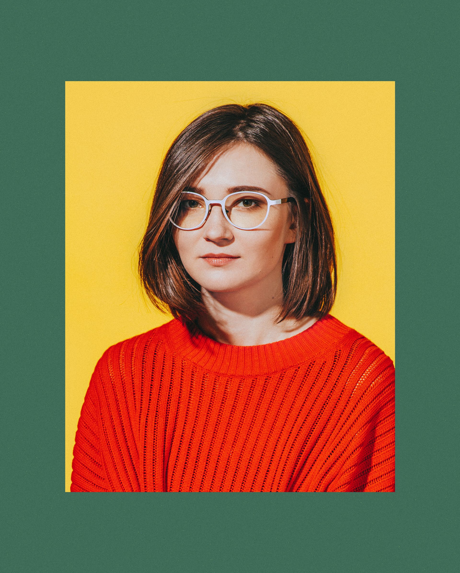 a closeup portrait of a young woman with shoulderlength brown hair, wearing whiteframed glasses and a bright red ribbed sweater. she is smiling subtly and looks directly at the camera. the background is a solid, bright yellow, creating a vibrant contrast with her attire. the overall mood is cheerful and contemporary.
