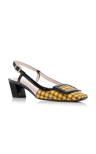 a yellow and black plaid slingback heeled shoe.  the shoe has a black heel and a yellow and black plaid top.  the shoe is a stylish addition to any wardrobe.
