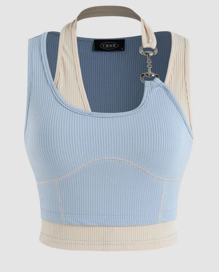 a light blue ribbed crop top with a creamcolored racerback halter top underneath. the halter top strap is connected to the blue top with silver hardware. the brand name "cider" is visible on a tag.