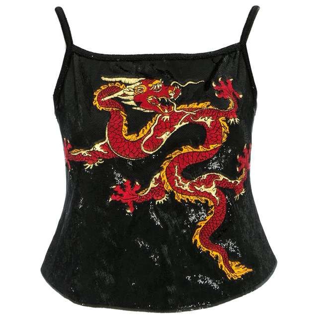 a black, shiny tank top featuring a large red and yellow dragon design. the top has spaghetti straps and a textured appearance.