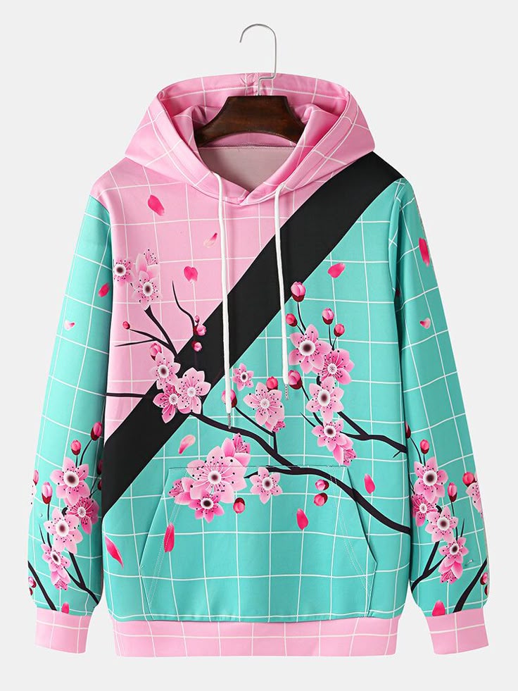 a hoodie with a pink and blue grid pattern featuring cherry blossoms and a black stripe across the chest. the hoodie is hanging on a hanger.