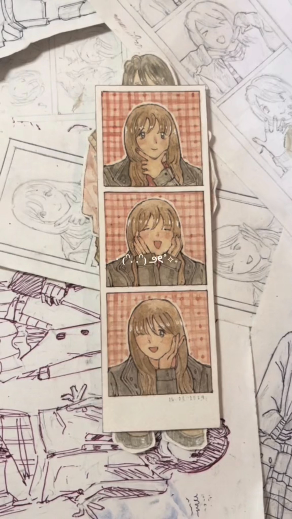 a photo strip of an anime girl. the strip has three pictures of the girl in different poses. the girl is wearing a black jacket and a white sweater. the pictures are set against a pink and white checkered background. the photo strip is drawn on paper, and the edges are frayed.