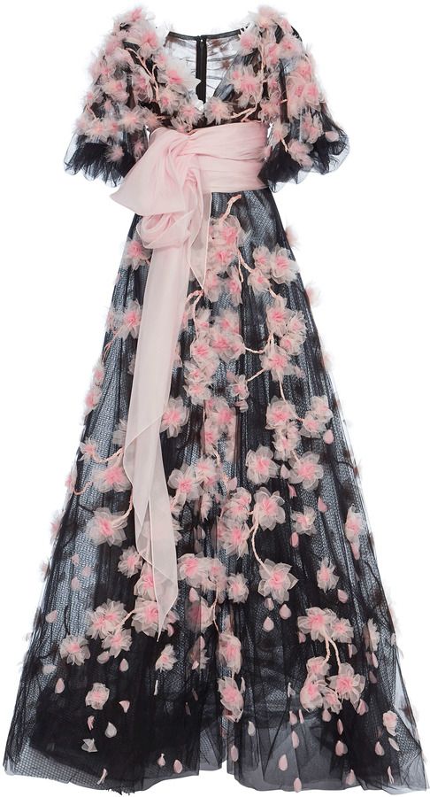 a black tulle evening gown with a pink belt and pink flowers. the gown has puff sleeves.
