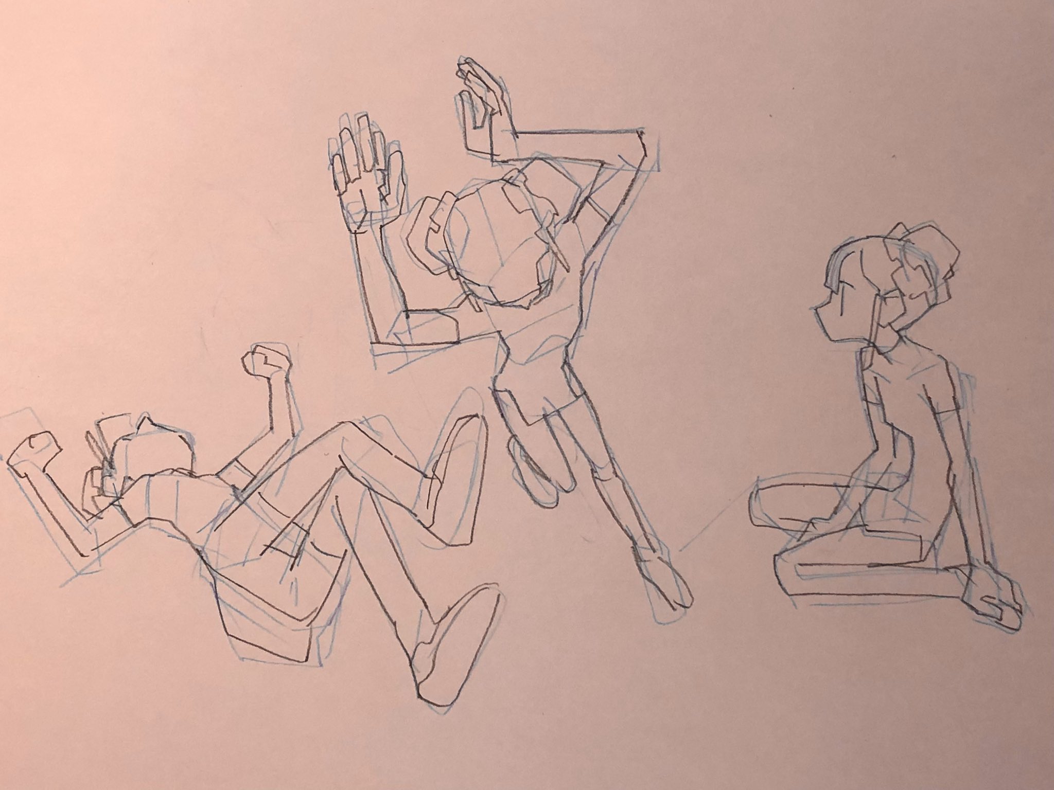 the image is a sketch of three figures in different dynamic poses. the figures are drawn with a blue pen on light pink paper. the lines are loose and fluid, capturing the movement of the figures. the figure on the left is lying on their back with their arms and legs outstretched. the figure in the middle is jumping in the air with their arms raised. the figure on the right is sitting on the ground with their legs crossed. the style of the sketch is cartoonish.