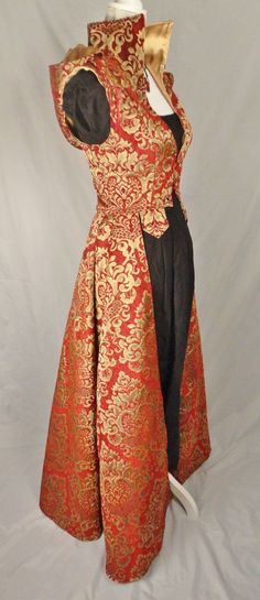 a red and gold brocade overdress with a high collar and long train. the dress is shown on a mannequin against a white background.