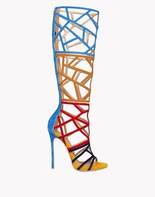 a vibrant, multicolored highheeled boot stands out against a plain white background. the boot's design features a complex geometric pattern constructed from straps of various colors: blue at the top, transitioning to orange, then red, and finishing with black and yellow at the toe. the stiletto heel is blue, adding to the boot's overall striking appearance. the open design reveals the foot, making it a unique and stylish footwear choice.