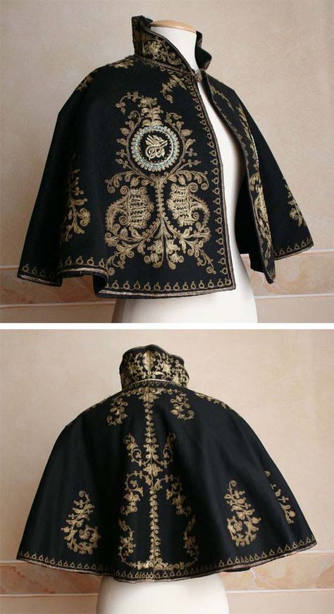 a black cape with intricate gold floral embroidery, showcasing a traditional and elegant design. the cape is likely antique or vintage and displays expert craftsmanship. the intricate details, ornate patterns, and fine textile suggest a rich cultural heritage and history.