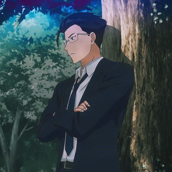 the image shows an anime man with short, dark hair and glasses. he is wearing a dark suit with a light blue tie and has his arms crossed. he is standing in a forest with his back against a tree and is looking to the left of the frame. the lighting is backlit and the overall tone of the image is muted.