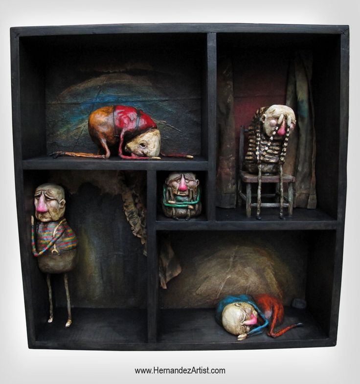 a shadow box containing various mixed media sculptures of humanoid figures, each depicting a melancholic or grotesque scene. the figures appear handcrafted and evoke a sense of isolation and oddity. the artist's website, hernandezartist.com, is displayed at the bottom.