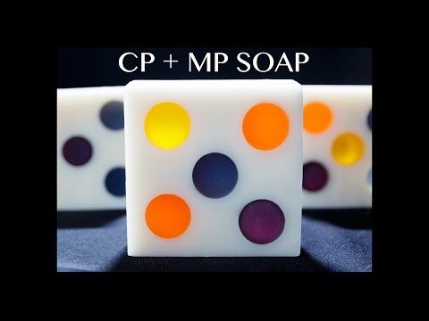 this image shows three bars of soap with a dot design. the middle bar is the main focus of the image. it is a white bar of soap with six dots in orange, yellow, purple, and blue. the soap on the left and right side of the main soap bar is not completely visible, but the design is the same. the background is a plain white.  the title at the top of the image reads "cp + mp soap".