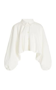 a white, cropped shirt with an oversized, puffy sleeve design and a buttondown collar. the shirt is made of a soft, casual fabric and is perfect for layering or wearing on its own. the shirt is a women's clothing item.