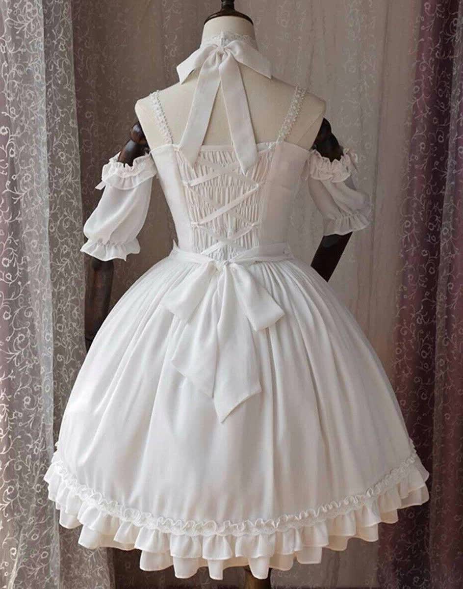 the image showcases the back of a white lolita fashion dress displayed on a mannequin. the dress features offtheshoulder puff sleeves, a lacetrimmed hemline, and a crisscross ribbon detail on the bodice with a large bow at the waist. the dress is floorlength and exudes an elegant and romantic aesthetic.